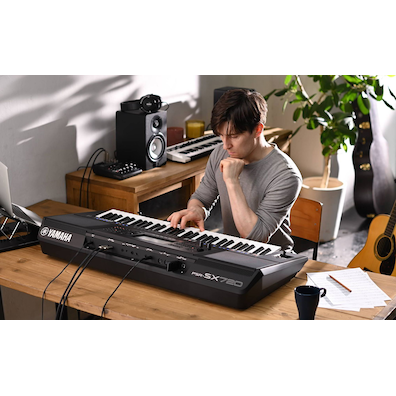 Photo of a person playing Yamaha Arranger Workstation PSR-SX720