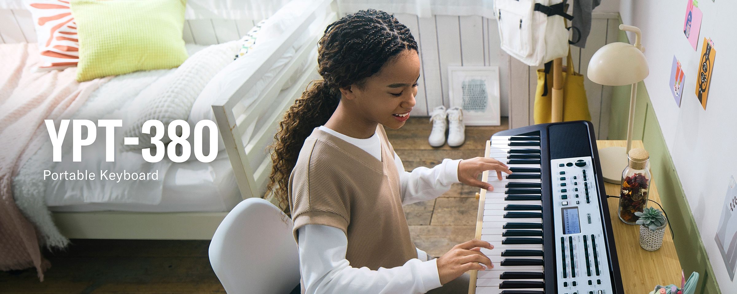 A girl playing the YPT-380