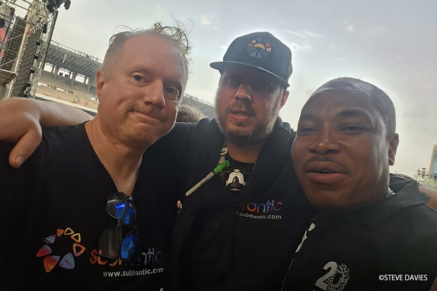 Steve Davies and Sam Wilkinson of Subfrantic with House On The Rock engineer Ebenezer OduGrandstand seating and event operations area with tents and attendees at The Experience 2025 in Lagos, Nigeria.mlami at The Experience 2025 in Lagos, Nigeria.
